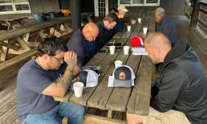 men praying campgroud_result